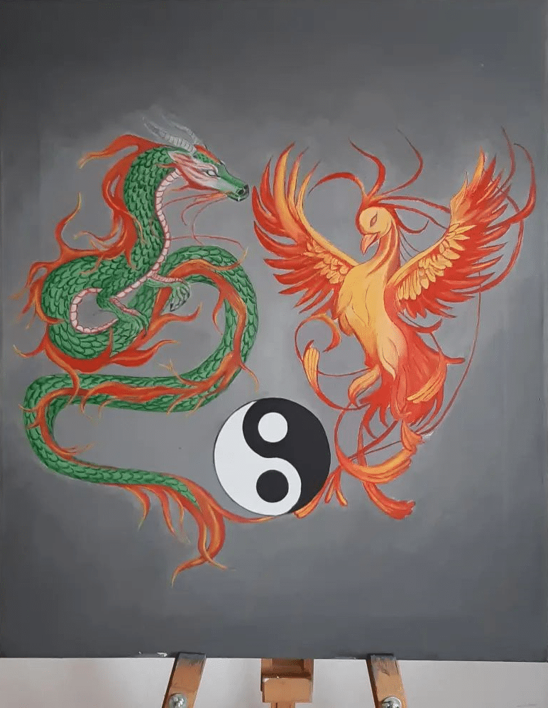 A painting with a dragon and phoenix with a symbol of Feng Shui.