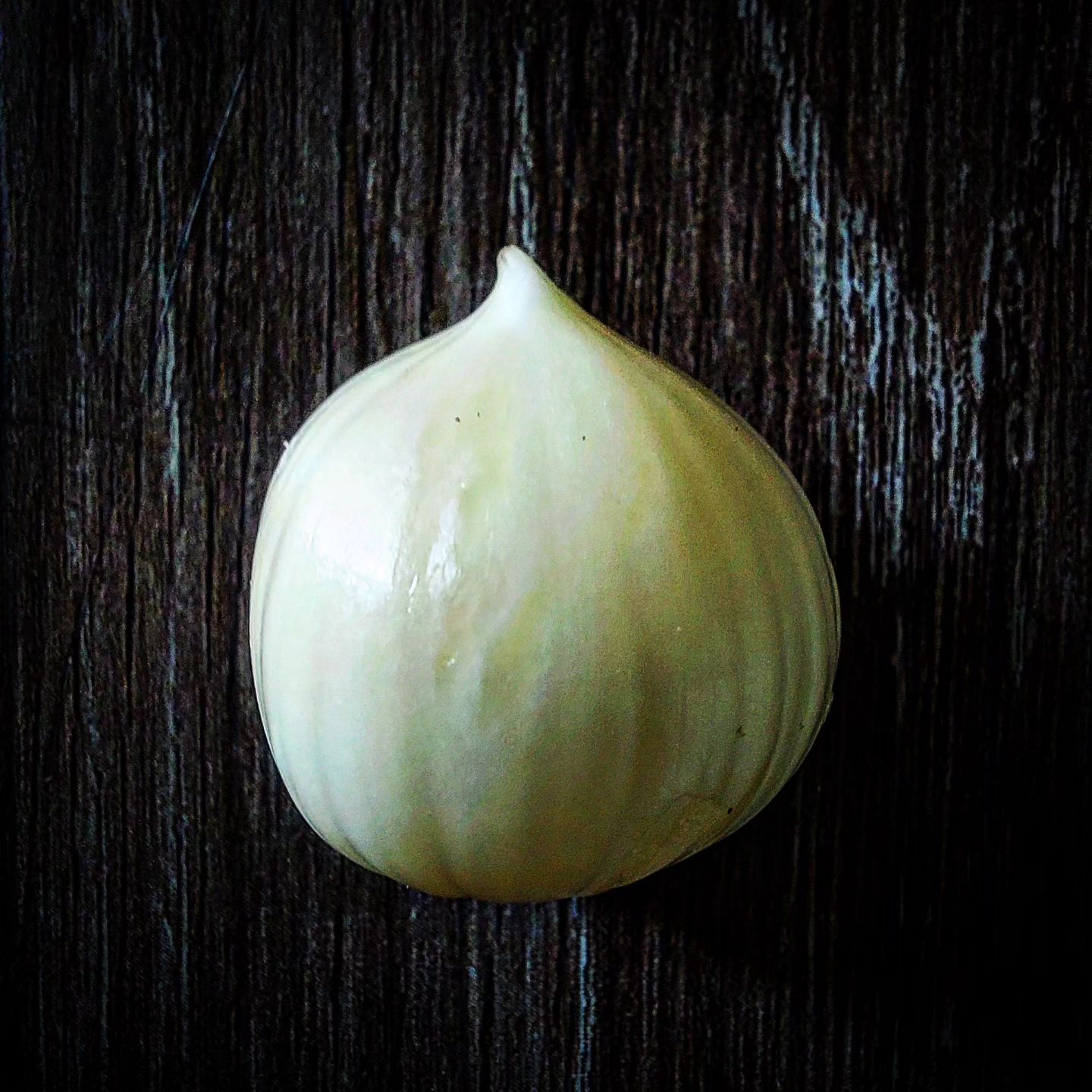 A portrait of cloveless garlic bulb or seeds peeled.